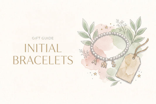 Illustration of a silver beaded bracelet with A, M and S initial charms beside a gift tag on string